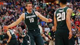 Matt Costello (10) and Travis Trice (20) of the Michigan State Spartans celebrate defeating the Louisville Cardinals 76 to 70 in overtime of the East Regional Final of the 2015 NCAA Men's Basketball Tournament at Carrier Dome on March 29, 2015 in Syracuse, New York.