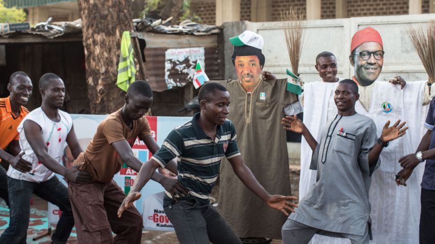 Young men dance in front of a makeshift figure of former military ruler and presidential candidate Muhammadu Buhari in Kaduna, which was hit hard by interreligious violence during the 2011 election, on March 29, 2015. Nigeria counted ballots in its closely fought general election after failures in controversial new technology pushed voting into a second day, with officials calling for calm in the tense wait for a winner. AFP PHOTO / NICHOLE SOBECKI (Photo credit should read Nichole Sobecki/AFP/Getty Images)