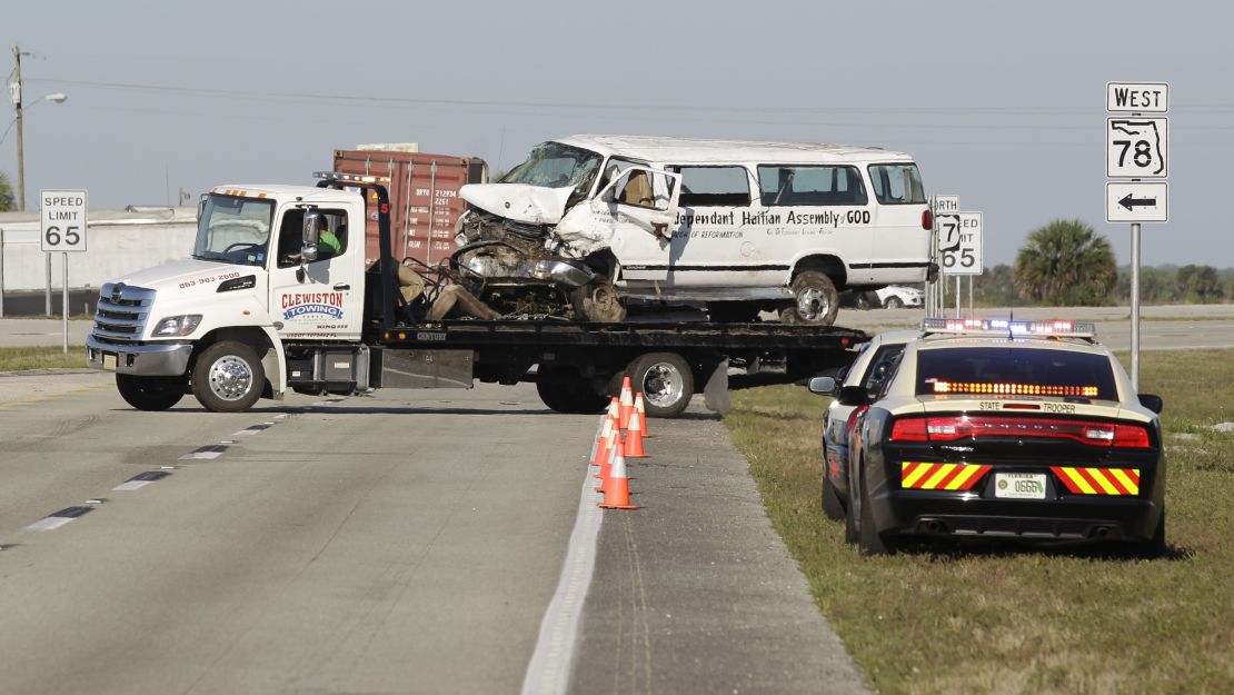 A tow truck on Monday moves the van that crashed into a canal in Glades County, Florida.
