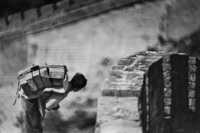 A man carries a load of stones on his back on the Great Wall in 1984. China restored the Great Wall at Badaling in 1984, making it more accessible. It's one of the most popular tourist sites in Beijing.