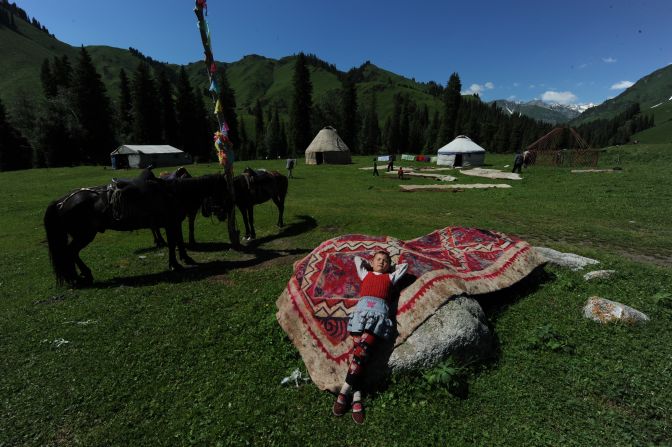 A boy from a nomadic family leans on a rug in 2010 near Ili, Xinjiang.