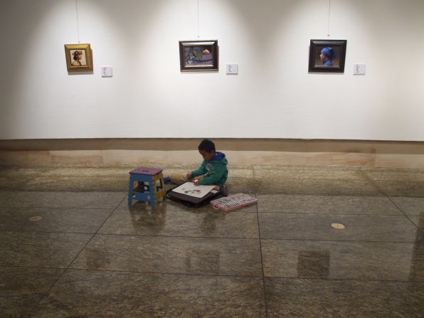 A boy draws in the National Art Museum of China, Beijing 2012. 