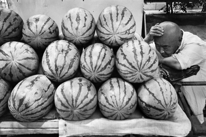 A watermelon vendor takes a nap in Beijing, 1995. Wang says he likes to capture life's more mundane moments.