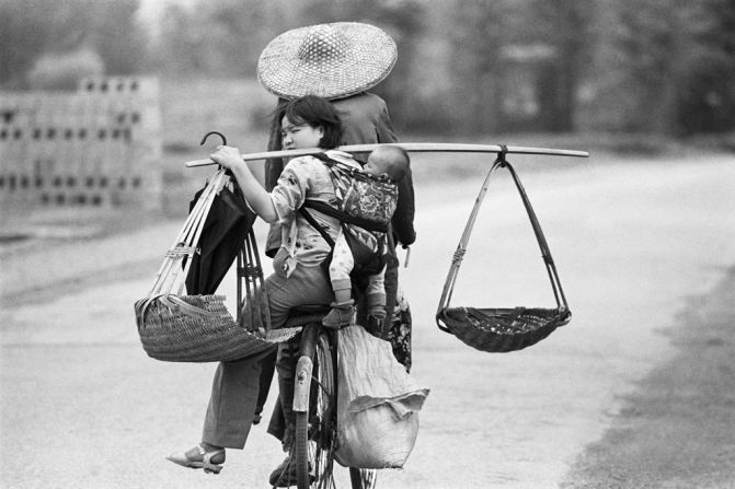 A family travels by bike in Guangxi, 1988. The bicycle once was a family's most precious asset.