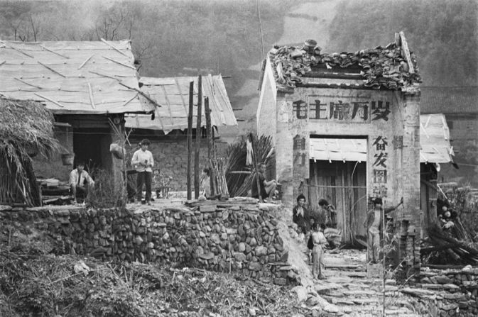 The village of Sanjiang, Guangxi photographed in 1988. The characters on the village gate read "Long live Chairman Mao" -- the most common political slogan during the Cultural Revolution. 