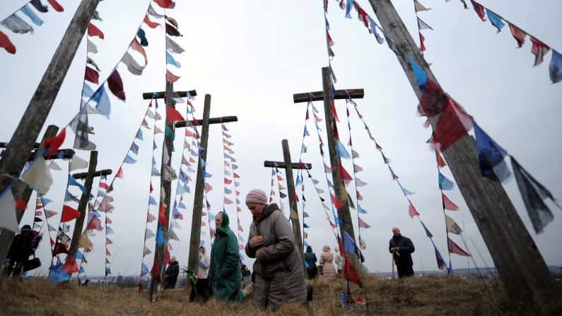 Catholics pray on a hill with wooden crosses in Oshmiany, Belarus, on March 29.