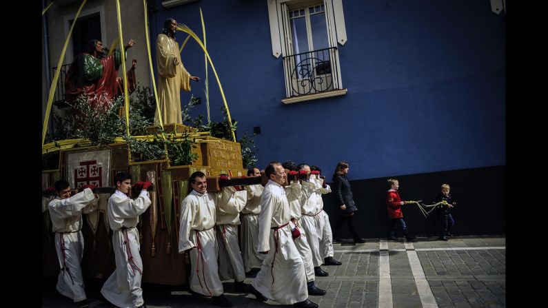 Penitents take part in a Palm Sunday procession in Pamplona, Spain, on Sunday, March 29. For Christians, Palm Sunday marks Jesus Christ's entrance into Jerusalem, when his followers laid palm branches in his path.