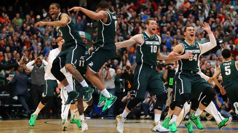 Michigan State basketball players celebrate Sunday, March 29, after they defeated Louisville in overtime to advance to the Final Four. The Spartans will take on Duke for a chance to play in the national championship game.