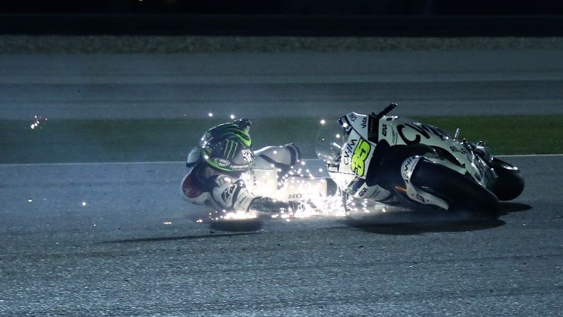 MotoGP rider Cal Crutchlow slides on the pavement Saturday, March 28, during a qualifying session for the Grand Prix of Qatar. Despite the fall, he raced the next day and finished seventh.