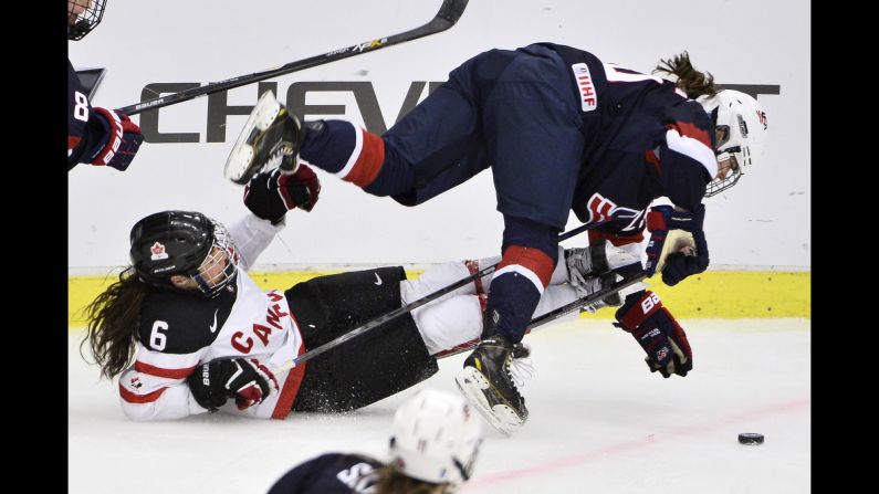 Canada's Rebecca Johnston, left, collides with Alex Carpenter of the United States during a World Championships game Saturday, March 28, in Malmo, Sweden. The tournament ends April 4.