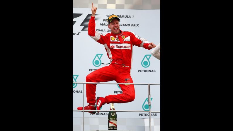 Sebastian Vettel celebrates on the podium after winning the Formula One race in Malaysia on Sunday, March 29. It was his first win since 2013.