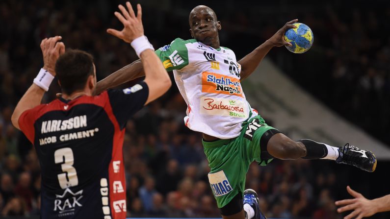 Tobias Karlsson of Flensburg challenges Kevynn Nyokas of Goeppingen during a Bundesliga handball match in Flensburg, Germany, on Wednesday, March 25.