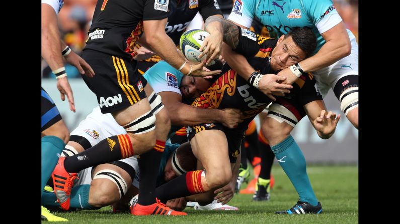 Sonny Bill Williams offloads the ball to a Chiefs teammate as he's being tackled by Central Cheetahs during a Super Rugby match Saturday, March 28, in Hamilton, New Zealand.