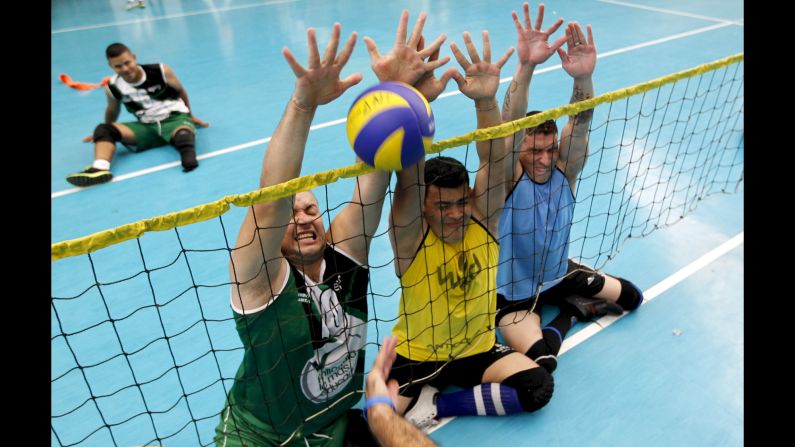 Colombian soldiers who were wounded by mines play sitting volleyball Wednesday, March 25, in Bello, Colombia.