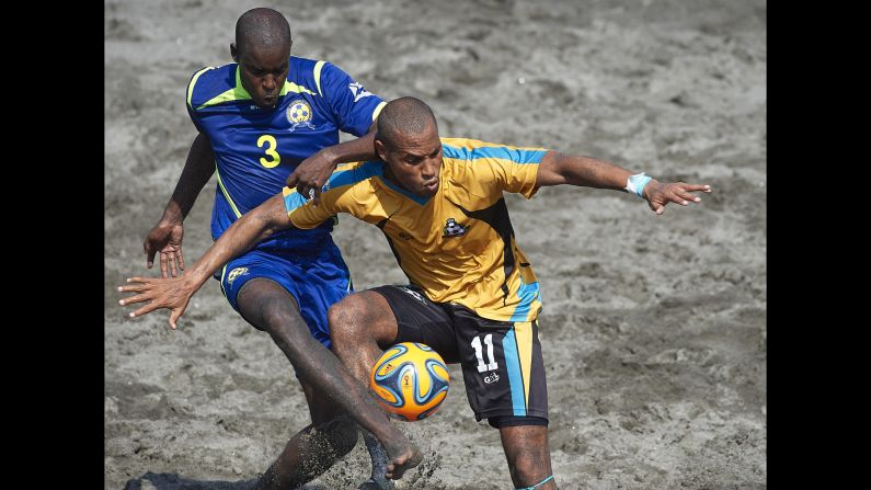 Gavin Christie of the Bahamas tries to shield the ball from Tito Grazette of Barbados during the final game of the CONCACAF Beach Soccer Championships on Saturday, March 28. The Bahamas won the match 10-4 in San Salvador, El Salvador.