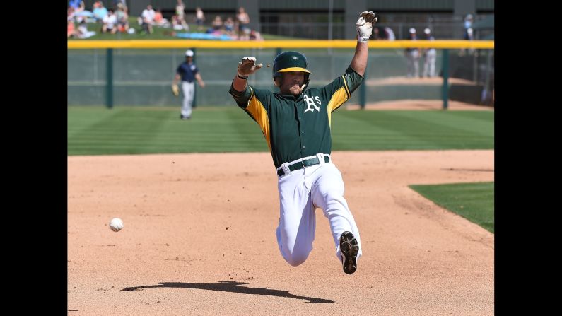 Oakland's Sam Fuld slides into third during a spring-training game Sunday, March 29, in Mesa, Arizona.