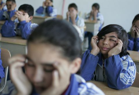 Students perform eye-exercises in a classroom at a bilingual middle school in China's far northwest Xinjiang. Eye exercises have been mandated in China since 1963 to help reduce the rate of eye disorders. Critics question their effectiveness. 