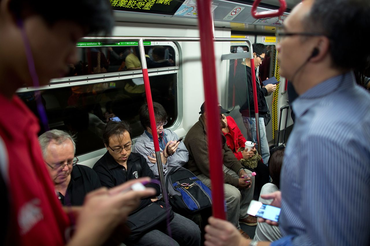In Hong Kong, rates of myopia are as high as 87%. This shows bespectacled passengers in Hong Kong riding the subway.