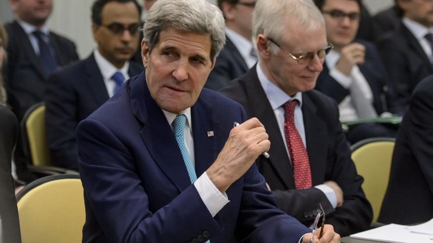 US Secretary of State John Kerry (L) gestures waiting for the opening of a plenary session with P5+1 ministers, European Union and Iranian minister on Iran nuclear talks at the Beau Rivage Palace Hotel in Lausanne, Switzerland, on March 31, 2015.