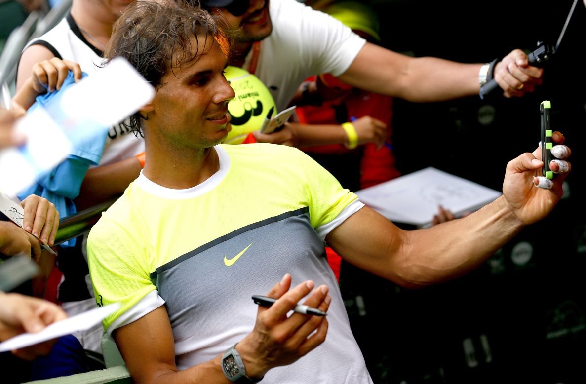 Tennis star Rafael Nadal takes a selfie for fans while signing autographs at the Miami Open on Friday, March 27.