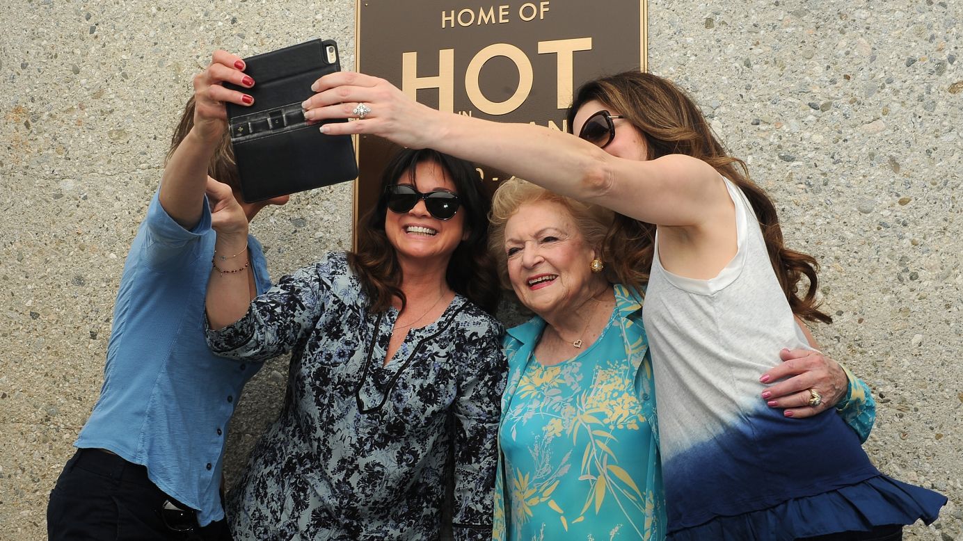 The stars of the TV show "Hot in Cleveland" -- from left, Wendie Malick, Valerie Bertinelli, Betty White and Jane Leeves -- take a selfie together Friday, March 27, in Studio City, California.