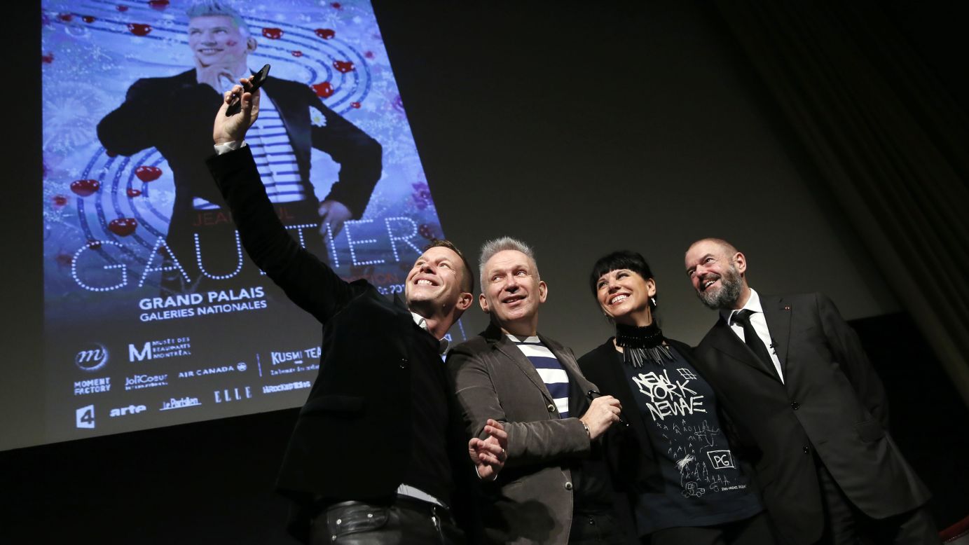 Fashion designer Jean Paul Gaultier, second from left, poses for a selfie prior to the opening of an exhibition devoted to him in Paris on Monday, March 30. The exhibition is  at the Grand Palais from April 1 to August 3.