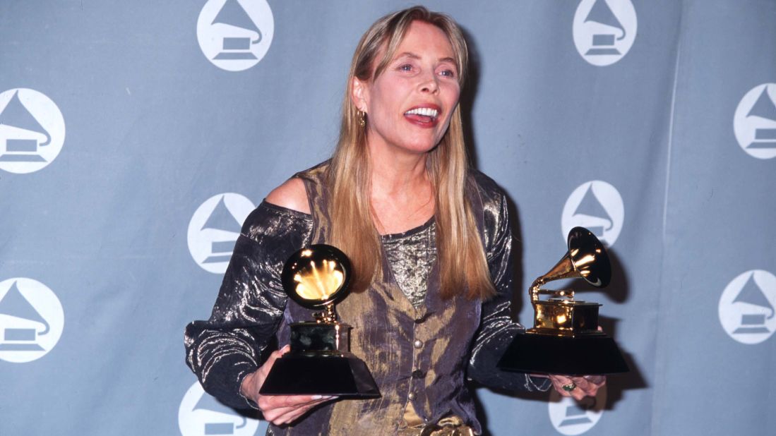 Mitchell holds her two Grammys after the 1996 award ceremony in Los Angeles. She won the best pop album and best recording package awards for "Turbulent Indigo." 