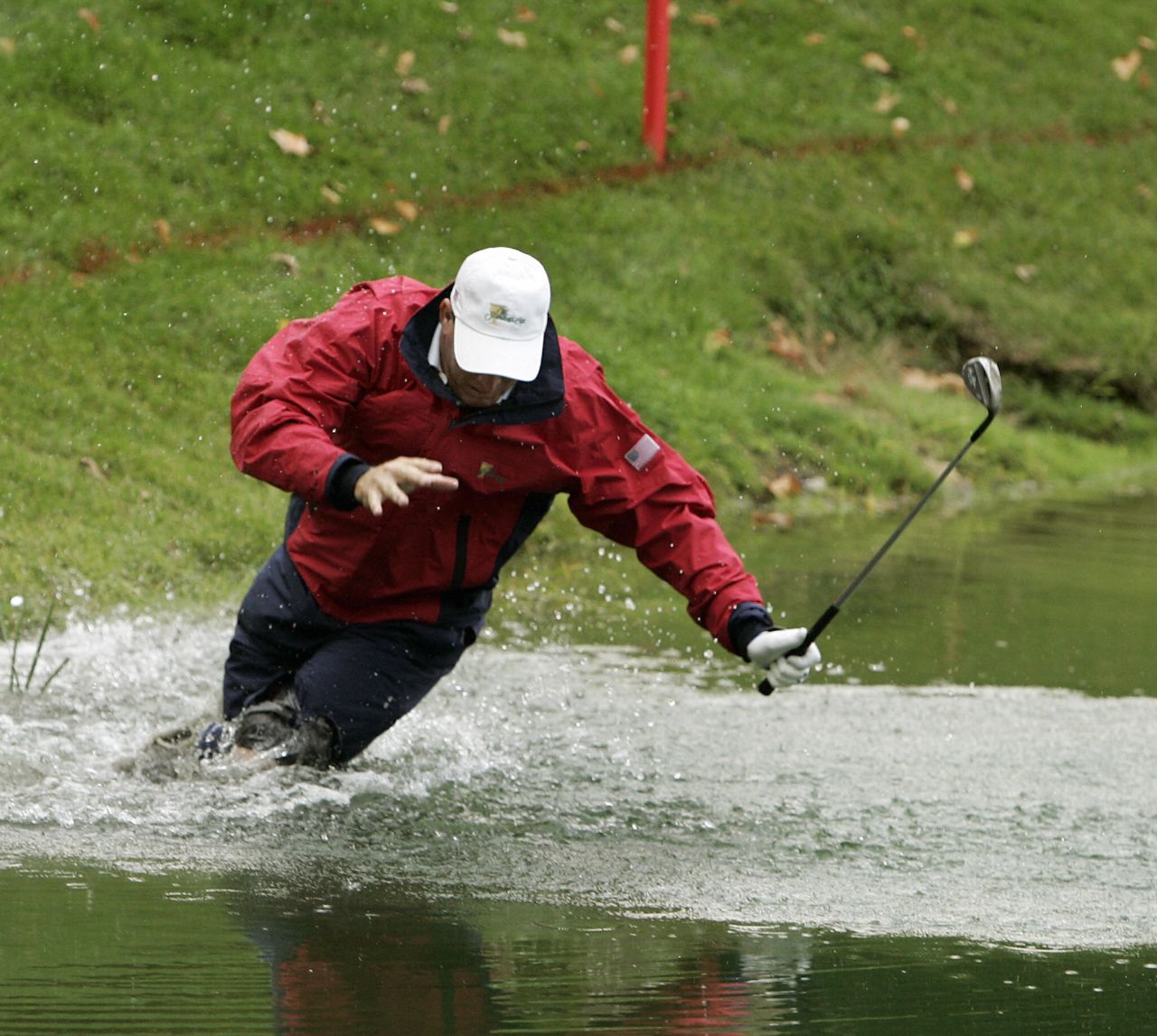 Golf-ball divers can make a thriving business from other people's misfortune. Here, U.S. player Woody Austin falls while hitting his ball out of the water at the four-ball matches of the 2007 Presidents Cup in Montreal, Canada.