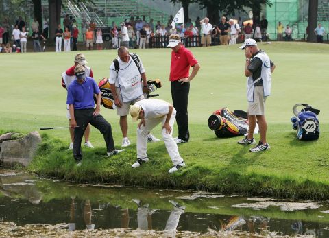 Players hunt for a wayward golf ball during the 2006 Players Championship of Europe. The visibility isn't much better underwater. "The balls are on the bottom, so as you start picking them up you're stirring up all the silt. If you could see before you started, you can't see while you're working," says diver Paul Lovelace.