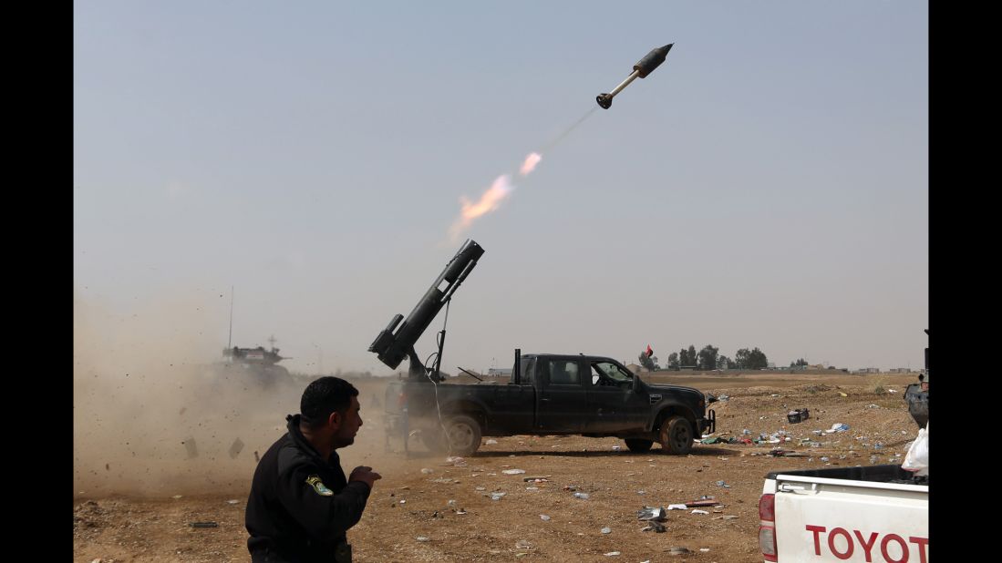 Iraqi security forces launch a rocket against ISIS positions in Tikrit on Monday, March 30.