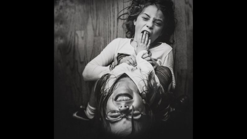 This is a typical moment from a snow day in Georgia, Parker said. The girls were playing under the dining room table, so Parker just stood on top of it and shot down, wondering, "When will school start again?" 