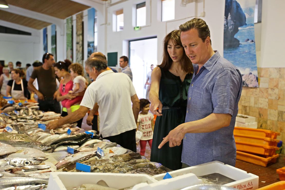 British Prime Minister David Cameron points at a fish during a visit to a fish market while on holiday in Portugal in 2013.