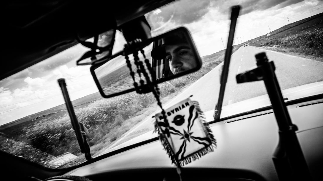 A militia member drives to Baqufa, Iraq, where Dwekh Nawsha and the Kurdish Peshmerga have been fighting the militant group. Freelance photographer Andy Sprya spent time with the militia photographing them in March 2015.