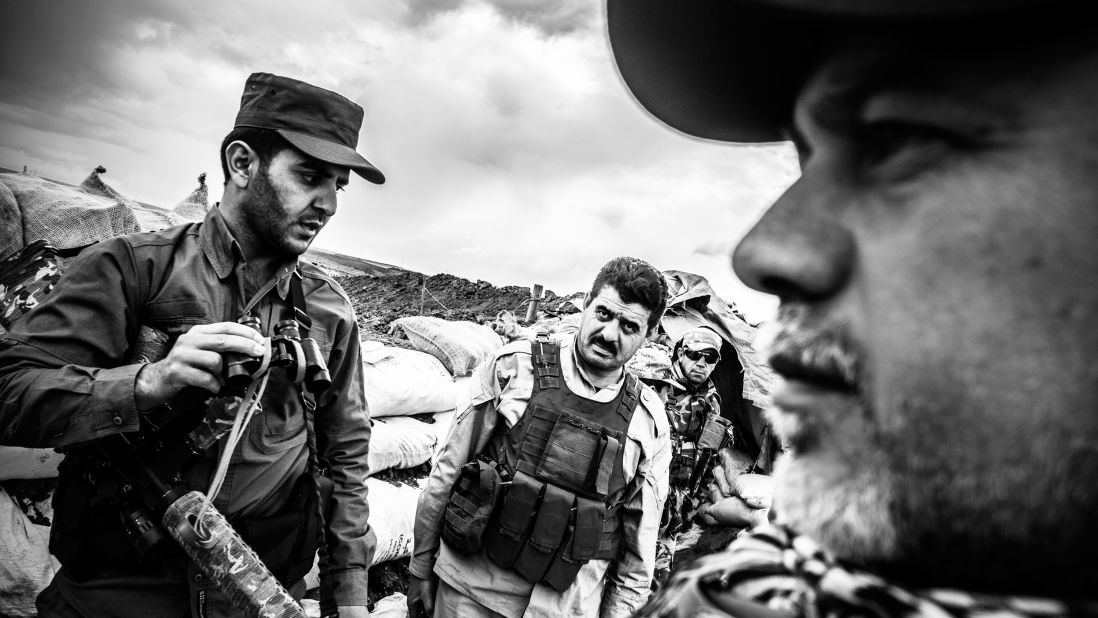 Albert Giso, right, is one of the local commanders of the Dwekh Nawsha militia. Here, he gives instructions to fighters on the front line in Baqufa.