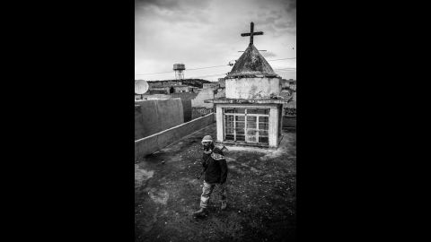 A Dwekh Nawsha fighter on the rooftop of a church in Baqufa. There are about 300,000 Christians in Iraq today, compared with 1.5 million 20 years ago, according to Christian relief organization CAPNI. 