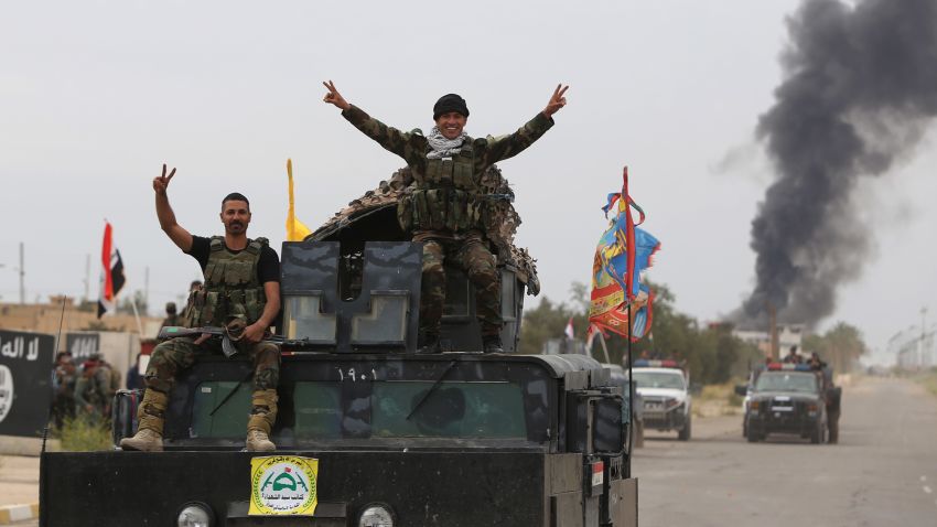 Iraqi security forces celebrate as they a street in Tikrit, on April 1, 2015, a day after the prime minister declared victory in the weeks-long battle to retake the city from the Islamic State (IS) group. Iraqi forces battled the last jihadists in the northern city on April 1, 2015 to seal a victory the government described as a milestone in efforts to rid the country of the Islamic State group. AFP PHOTO / AHMAD AL-RUBAYEAHMAD AL-RUBAYE/AFP/Getty Images