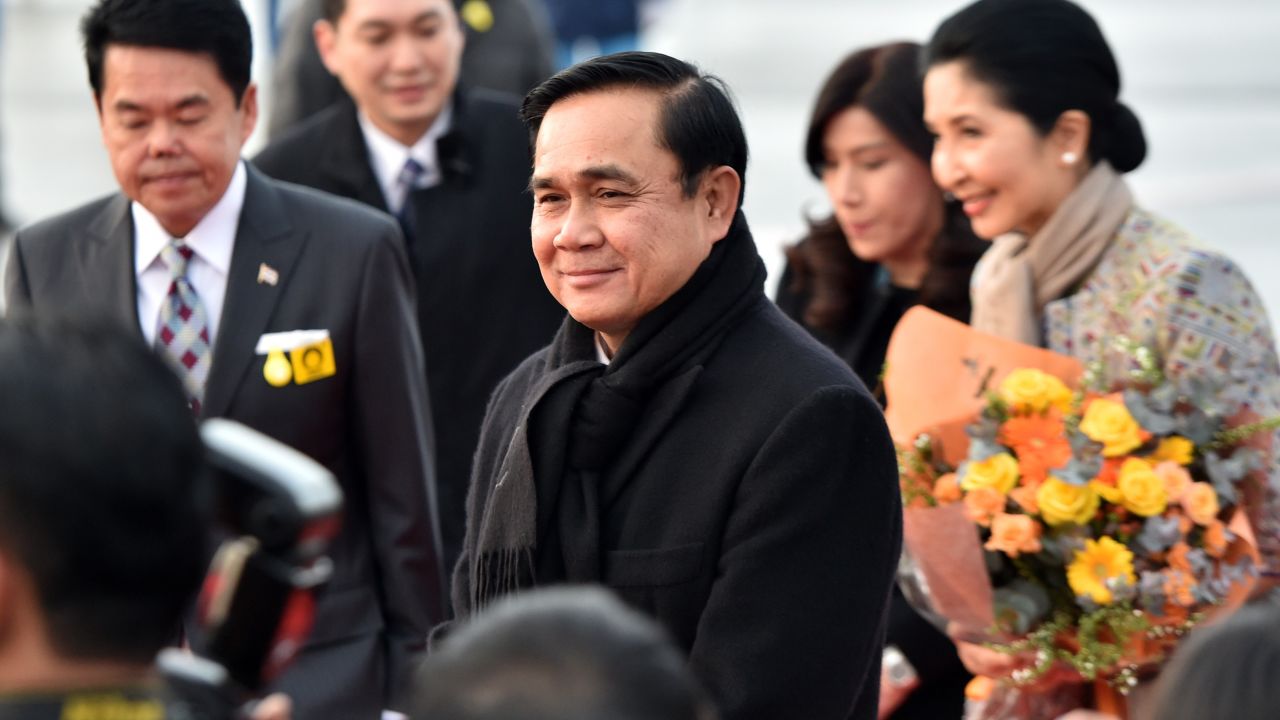 Thai Prime Minister Prayut Chan-O-Cha (C), accompanied by his wife Naraporn (R), arrives at Tokyo International Airport on February 8, 2015. 