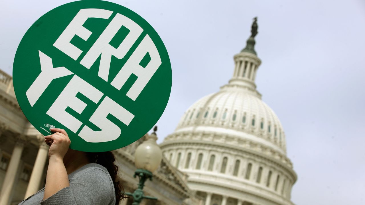 Caption:WASHINGTON, DC - MARCH 22: A woman hold up a sign as members of Congress and representatives of women's groups hold a rally to mark the 40th anniversary of congressional passage of the Equal Rights Amendment (ERA) outside the U.S. Capitol March 22, 2012 in Washington, DC. Rep. Carolyn Maloney (D-NY) and Sen. Robert Menendez (D-NJ) introduced a new version of the Equal Rights Amendment last year and called for it to be passed again. (Photo by Chip Somodevilla/Getty Images)