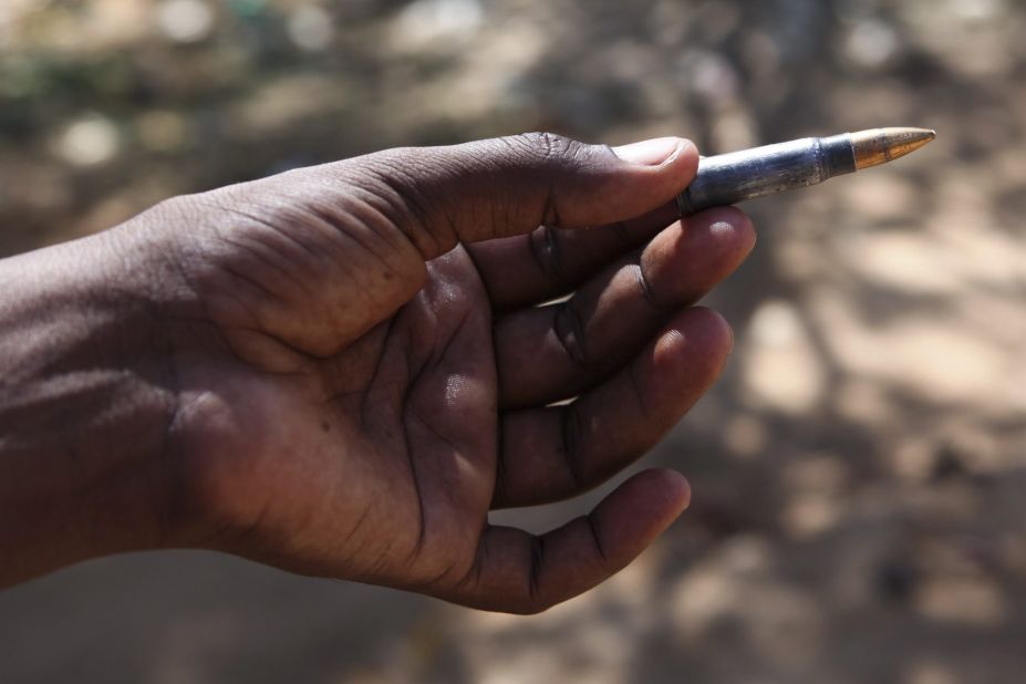 A local resident shows a bullet allegedly from the militants in front of the school.