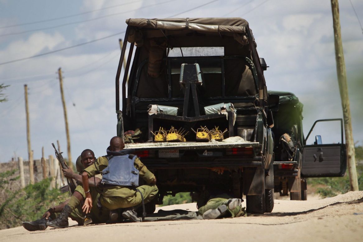 Kenyan soldiers take cover as shots are fired in front of the university on April 2, 2015.