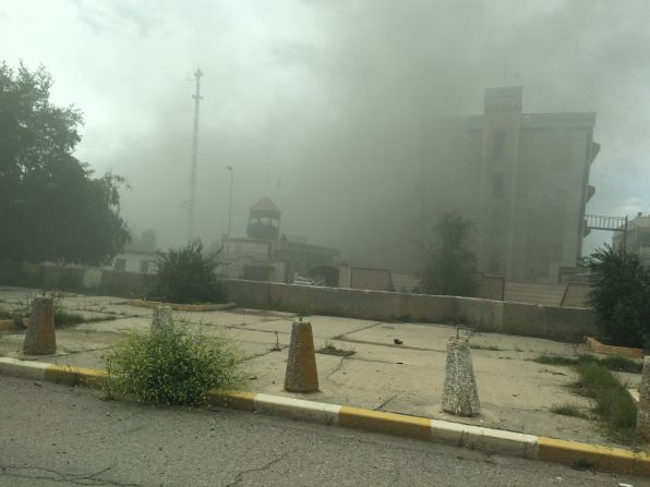 Smoke rises from a government building. As Iraqi forces, aided by Shiite militiamen, took control of Tikrit on April 1, they found vehicles laden with explosives and buildings that might be booby-trapped.