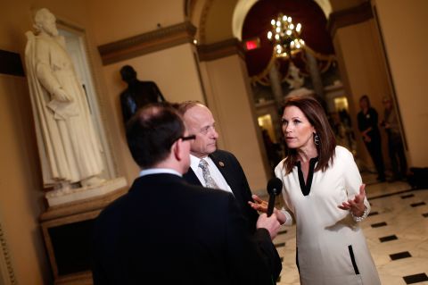 Rep. Michele Bachmann, R-Minnesota, right, and Rep. Steve King, R-Iowa, center, talk with a reporter at the U.S. Capitol as the House of Representatives continues a temporary recess on December 11, 2014, during her last month in office. Here's a look back at her political career. 