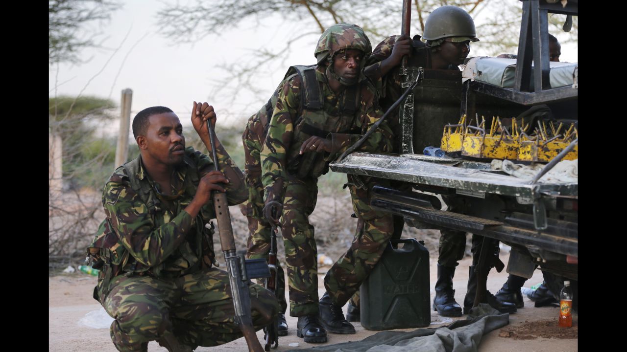 Kenyan soldiers take cover as heavy gunfire continues in front of the school on April 2, 2015.