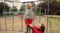 BERLIN, GERMANY - JUNE 06:  A mother plays with her three-year-old daughter on a playground on June 6, 2012 in Berlin, Germany. The Betreuungsgeld (child care subsidy), proposed to take effect in January 2013, would give parents that keep their children at home instead of sending them to a kindergarten €150 per child per month, causing concern amongst critics who feel that the state support would foster traditional family values as well as provide an incentive for low-income families to keep their children at home. The government has meanwhile planned to guarantee the right to placement in a Kindergarten from August 2013.  (Photo by Adam Berry/Getty Images)