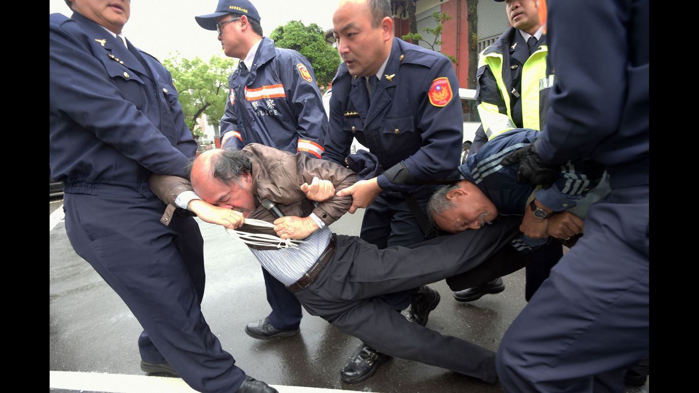 Police in Taipei, Taiwan, remove independence activists from Parliament during a protest on Friday, March 27.