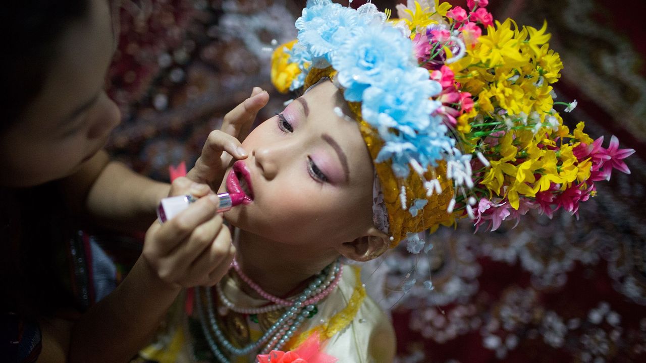 Relatives apply makeup to a boy's face Wednesday, April 1, during the Poy Sang Long festival in Mae Hong Son, Thailand. Poy Sang Long is a rite-of-passage ceremony for the Shan people in Myanmar and northern Thailand. Boys between 7 and 14 are ordained as novices to learn the Buddhist doctrines.