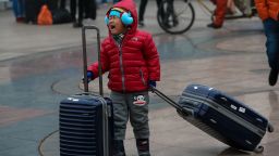 BEIJING, CHINA - FEBRUARY 28: A child cries as he waits his mother at Beijing Railway station on February 28, 2015 in Beijing, China.  (Photo by Emmanuel Wong/Getty Images)