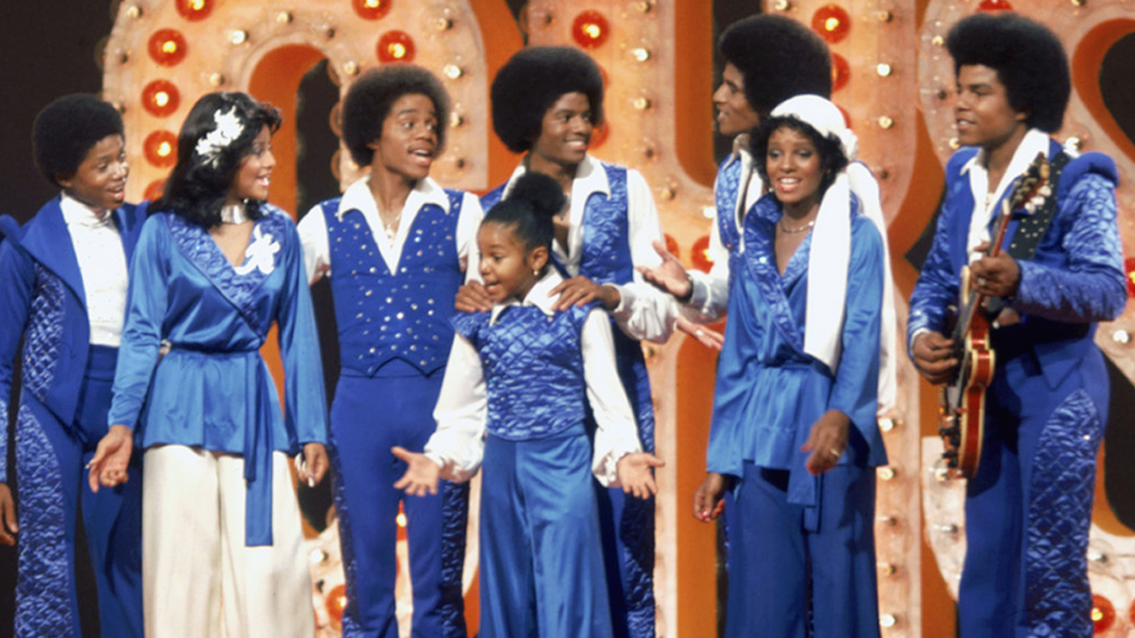 The Jackson family film a TV show at Burbank Studios, California, 13th November 1976. From left to right, Randy, La Toya, Marlon, Janet, Michael, Jackie, Rebbie and Tito. 
