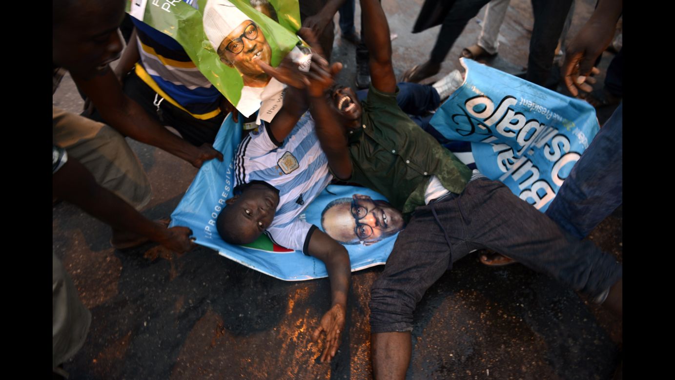 Two men in Lagos, Nigeria, lie on posters Tuesday, March 31, as they celebrate Muhammadu Buhari's victory in the country's presidential election. <a href="http://www.cnn.com/2015/04/01/africa/nigeria-presidential-election/index.html" target="_blank">Buhari defeated incumbent Goodluck Jonathan</a> by about 2 million votes, according to Nigeria's Independent National Electoral Commission. It is the first time in Nigeria's history that the opposition has defeated the ruling party in democratic elections.