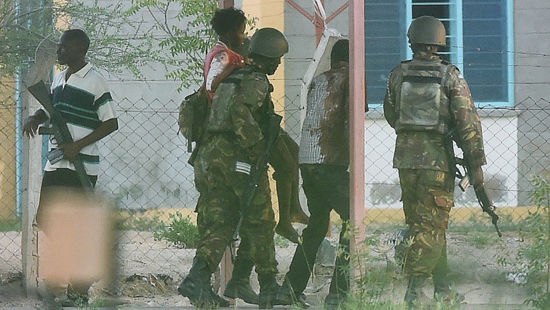 A student hostage is escorted out of the school after troops ended the gunmen's siege on April 2, 2015.